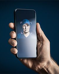 Phone with an AI scan image of a man's face